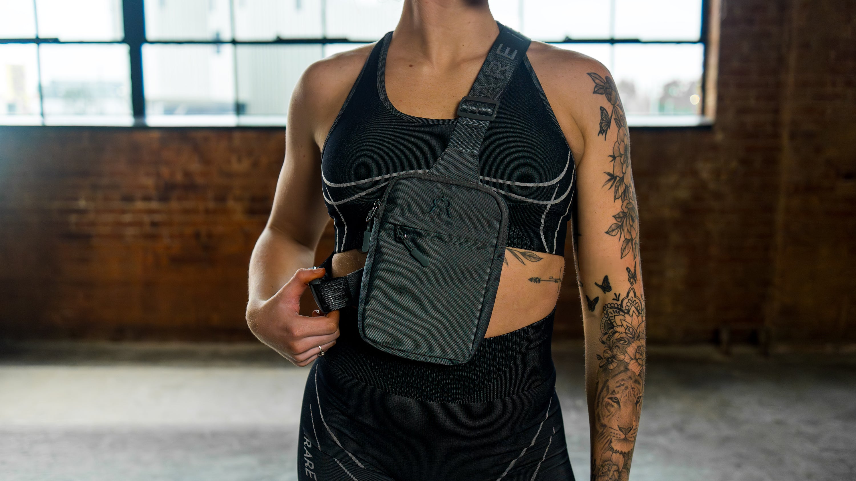 iRARE gray crossbody bag worn across chest with jacquard strap