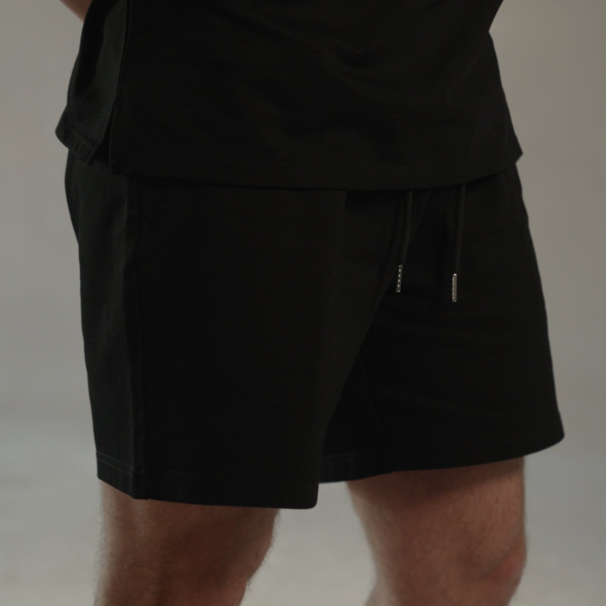 men’s relaxed sweat shorts in black, side close-up