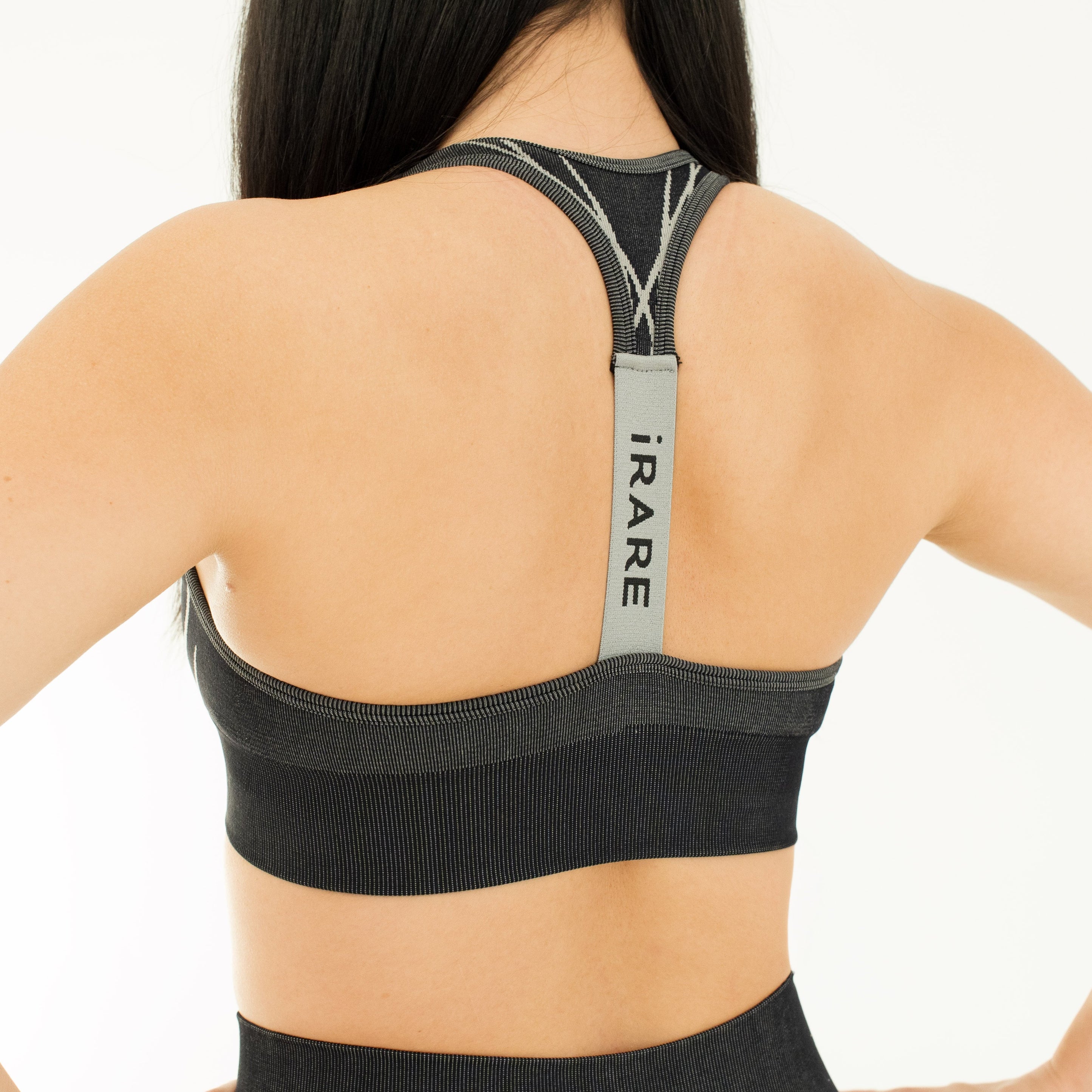 seamless sports bra in black, back view, studio