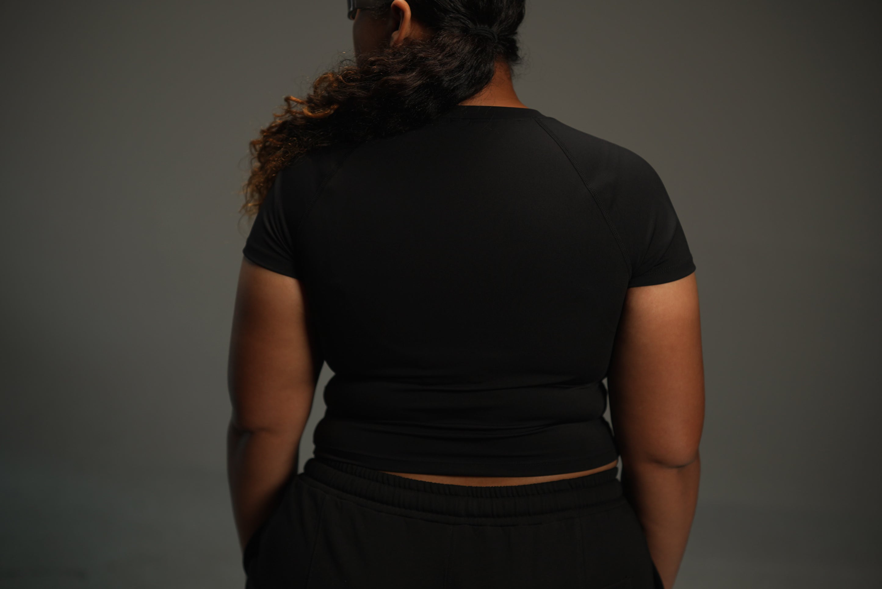 short-sleeve raglan top in black, back view close-up