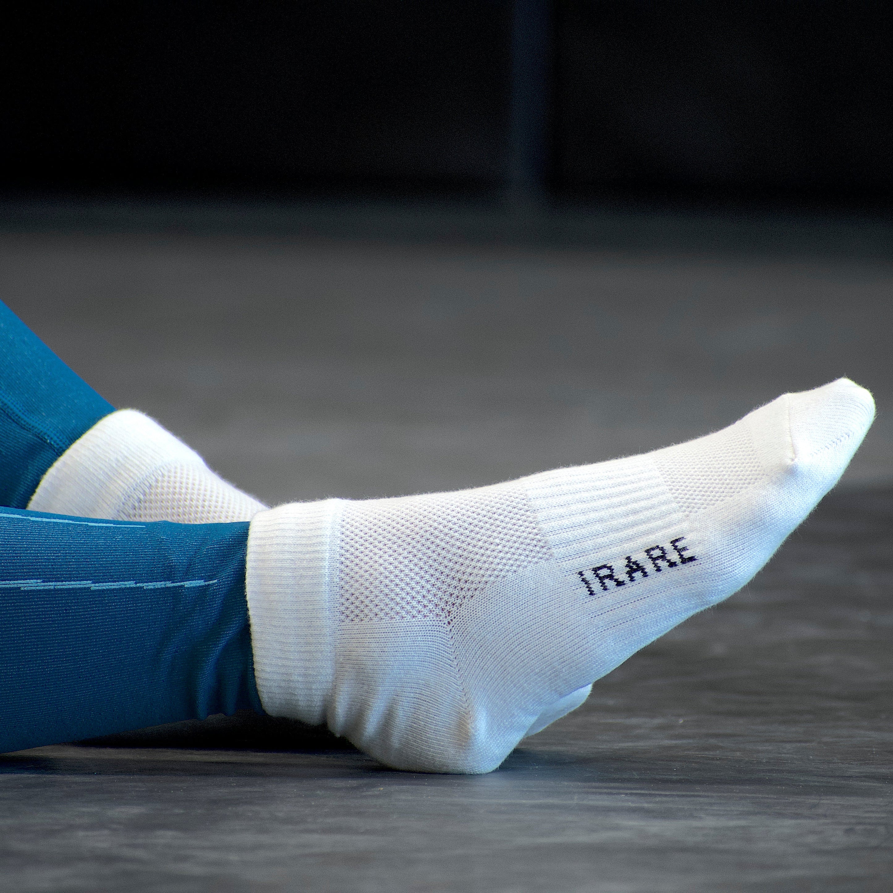unisex ankle socks in white, gym floor, side view