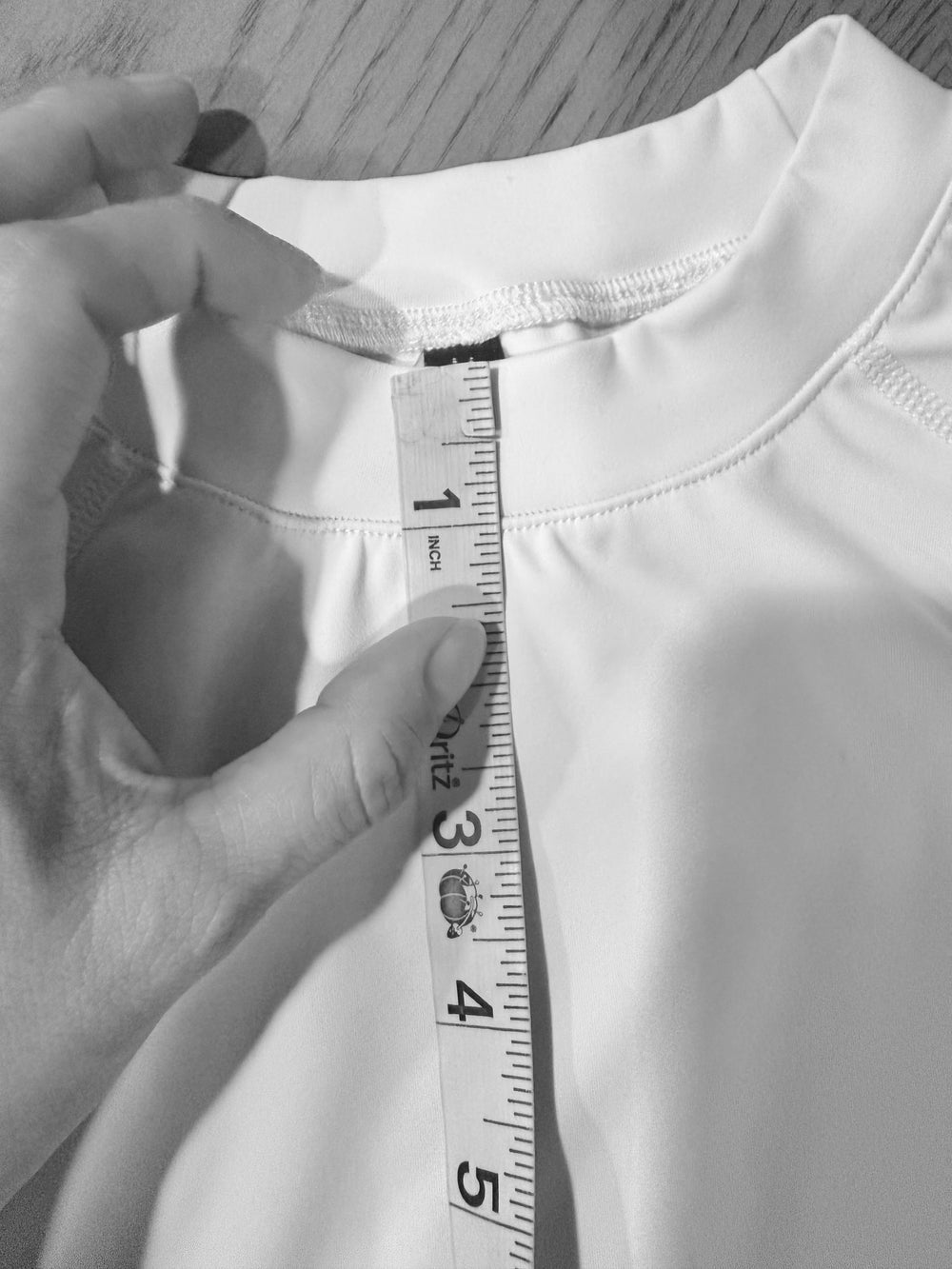 Measuring the neckline of a white garment