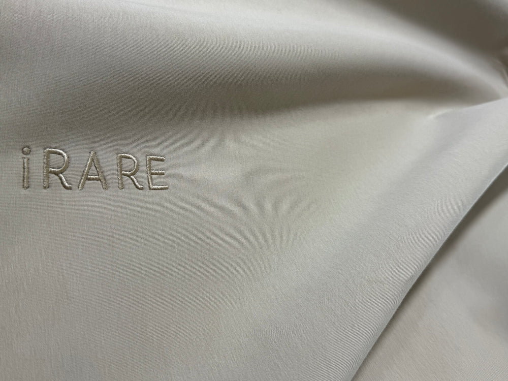 iRARE embroidery on light-colored fabric