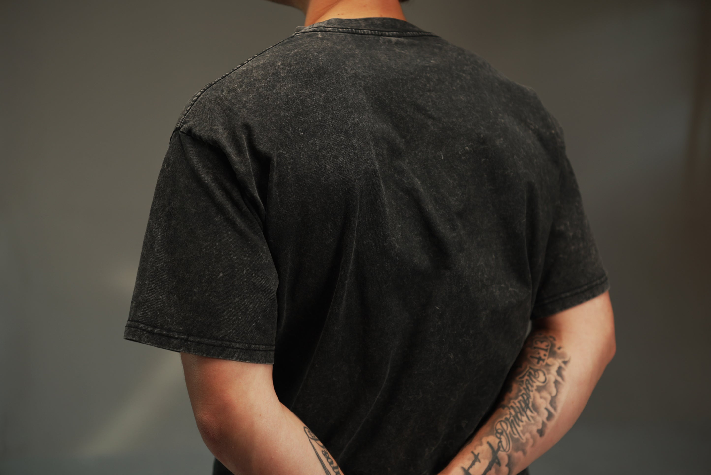 men’s acid-washed t-shirt in black, washed back view