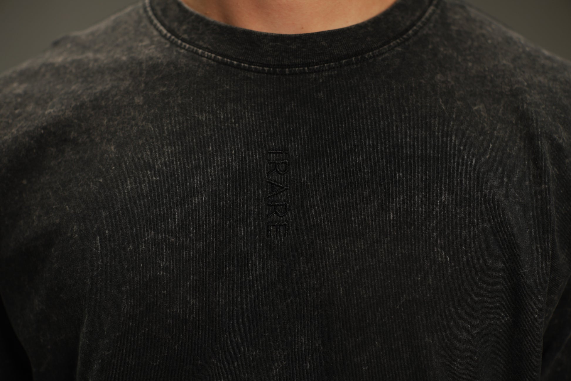 embroidered logo close-up on washed black t-shirt