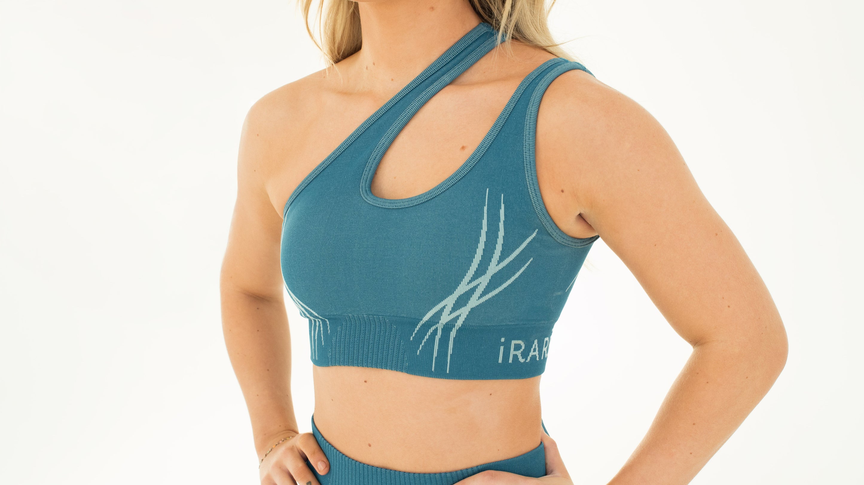 blue one-shoulder seamless sport bra, studio front view