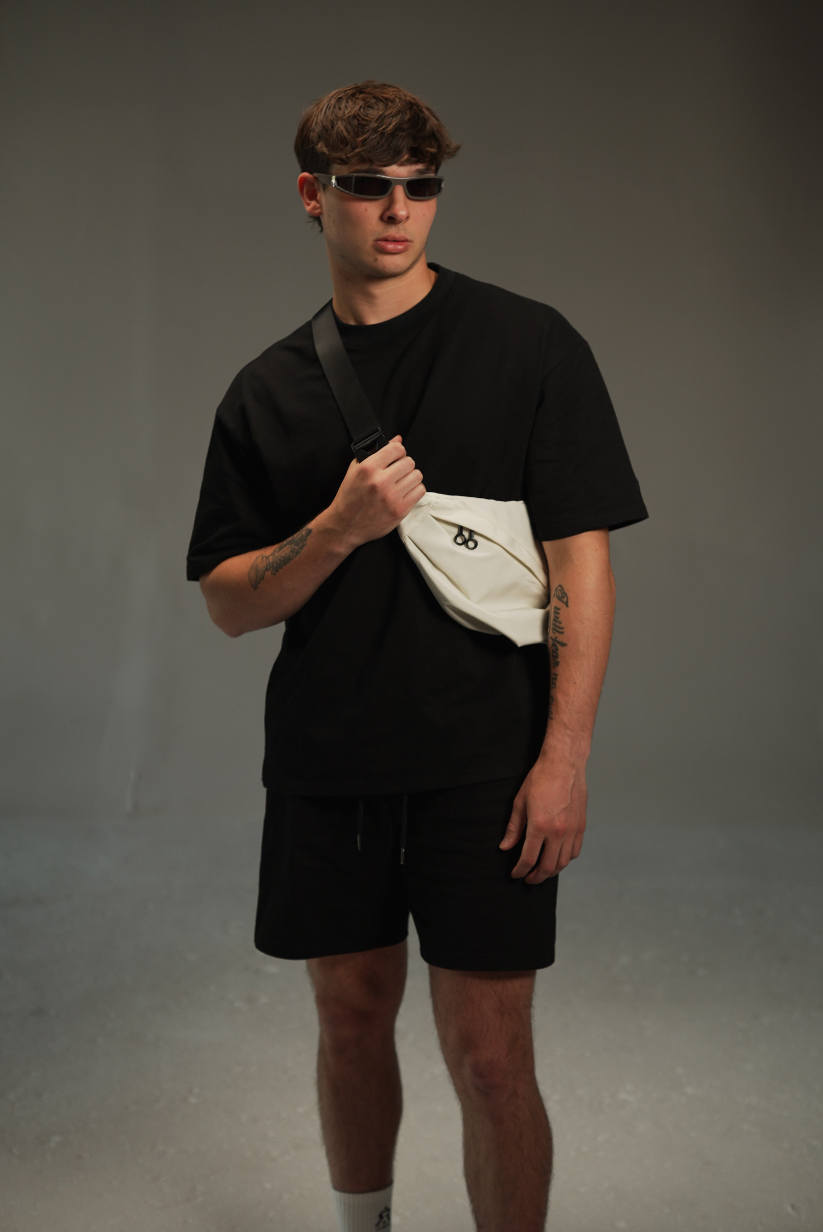 cream large crossbody sport bag styled on male model