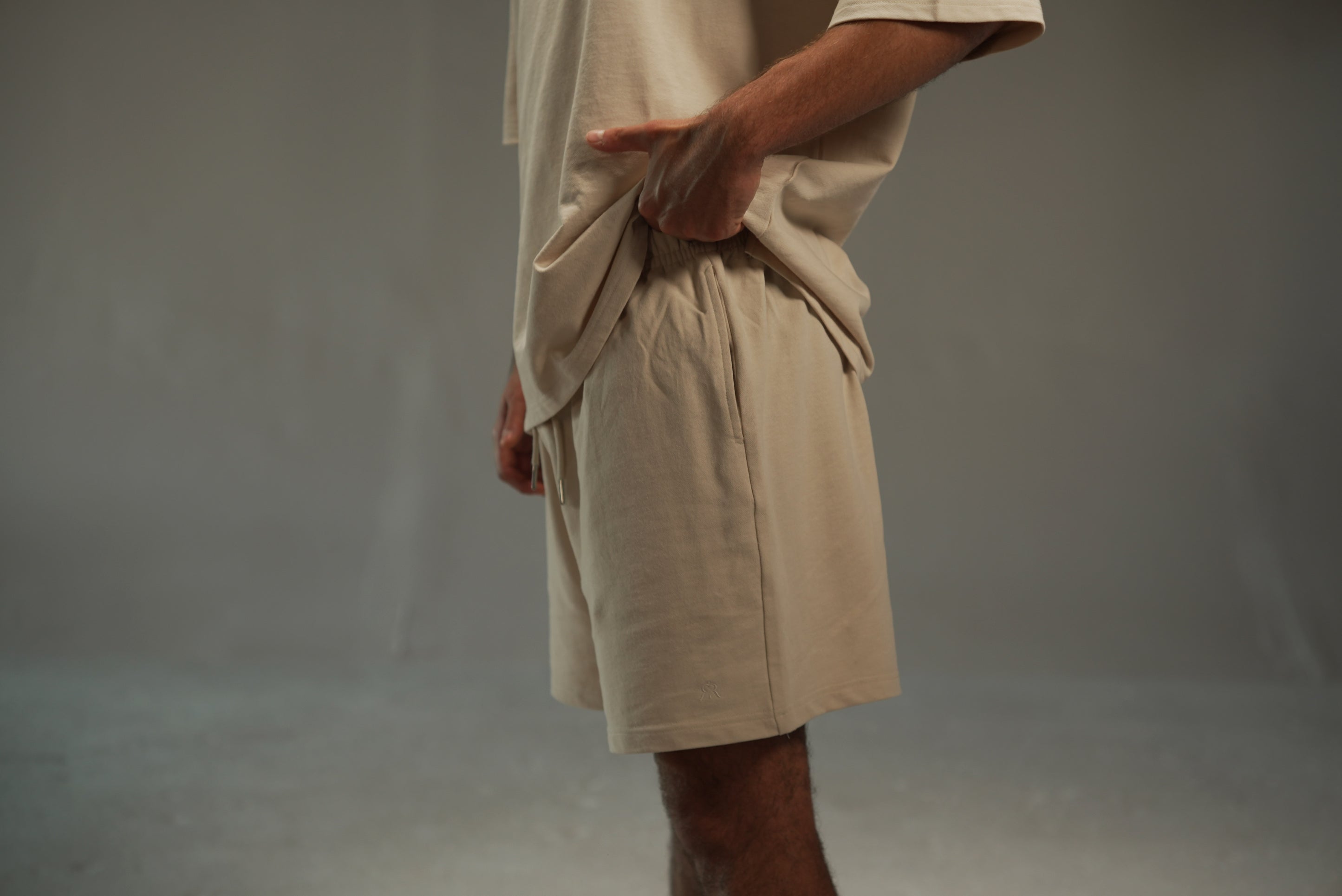 men’s relaxed sweat shorts in khaki, side view, pocket