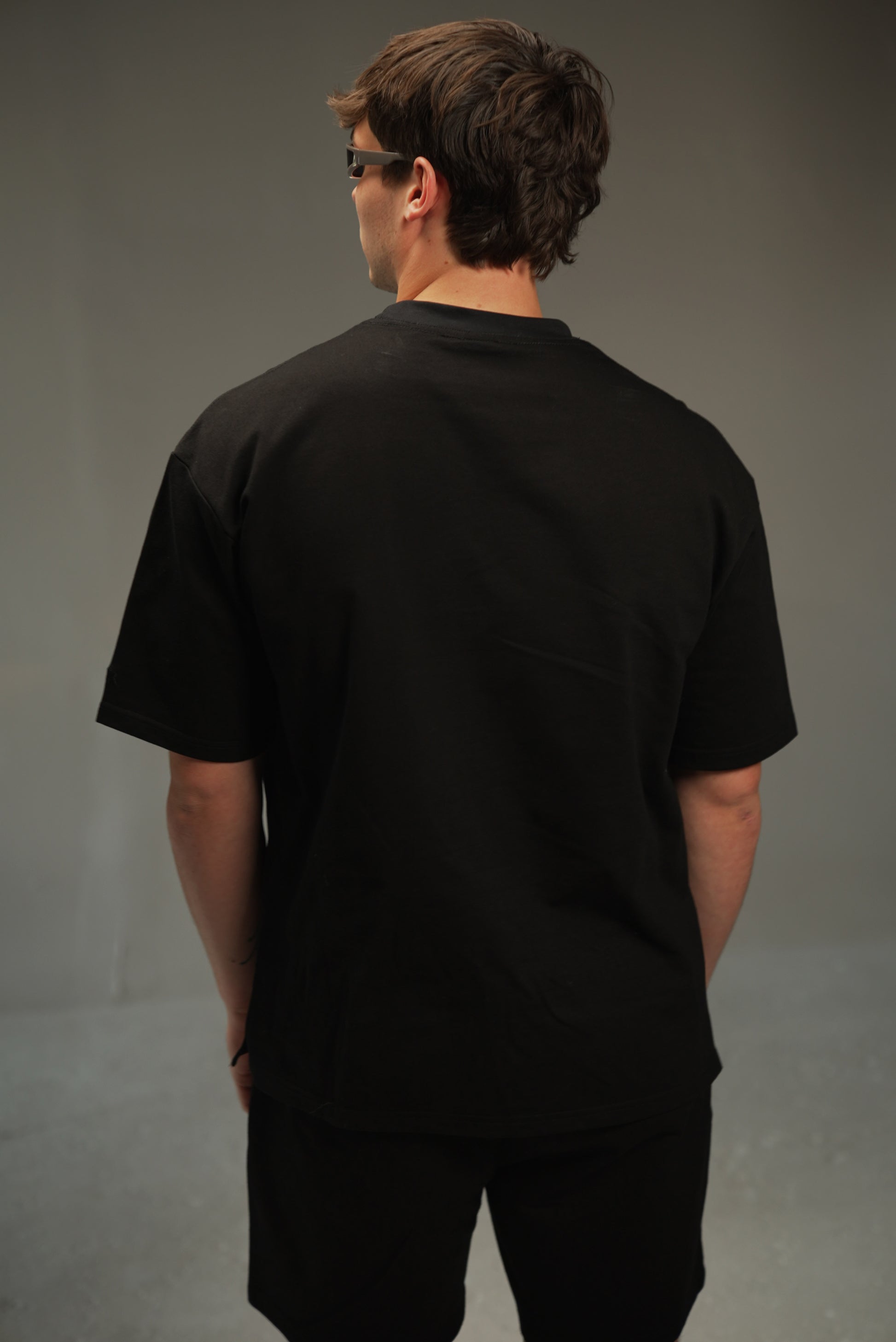men’s relaxed sweatshirt in black, on-model back