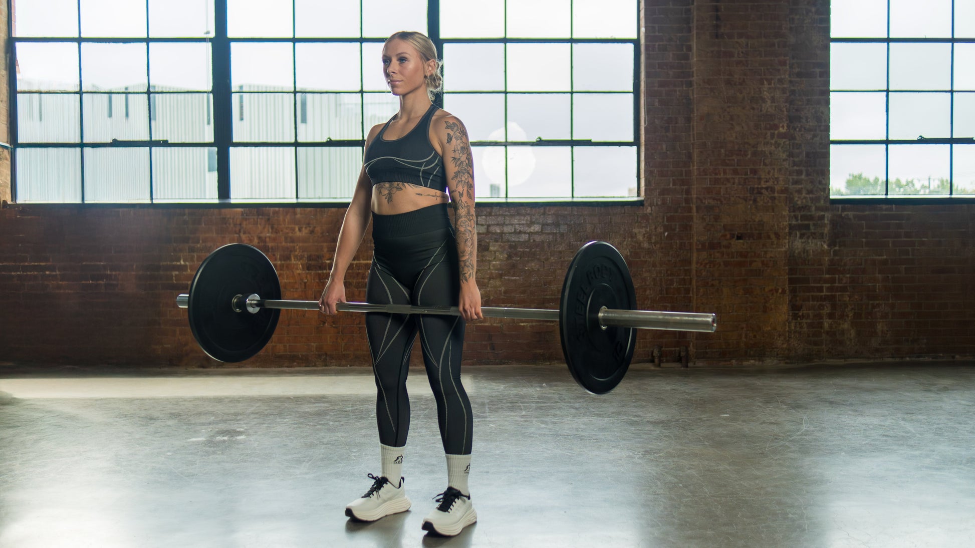 black seamless leggings, on-model training pose with matching sport bra