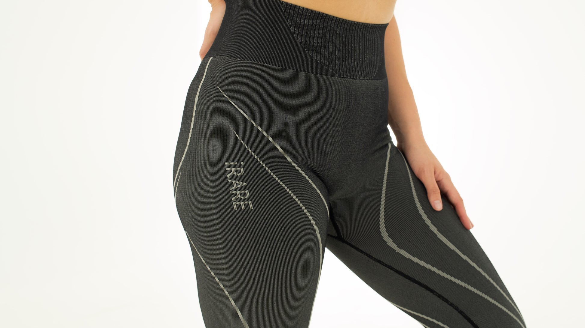side close-up of black seamless leggings with rib detail and jacquard logo