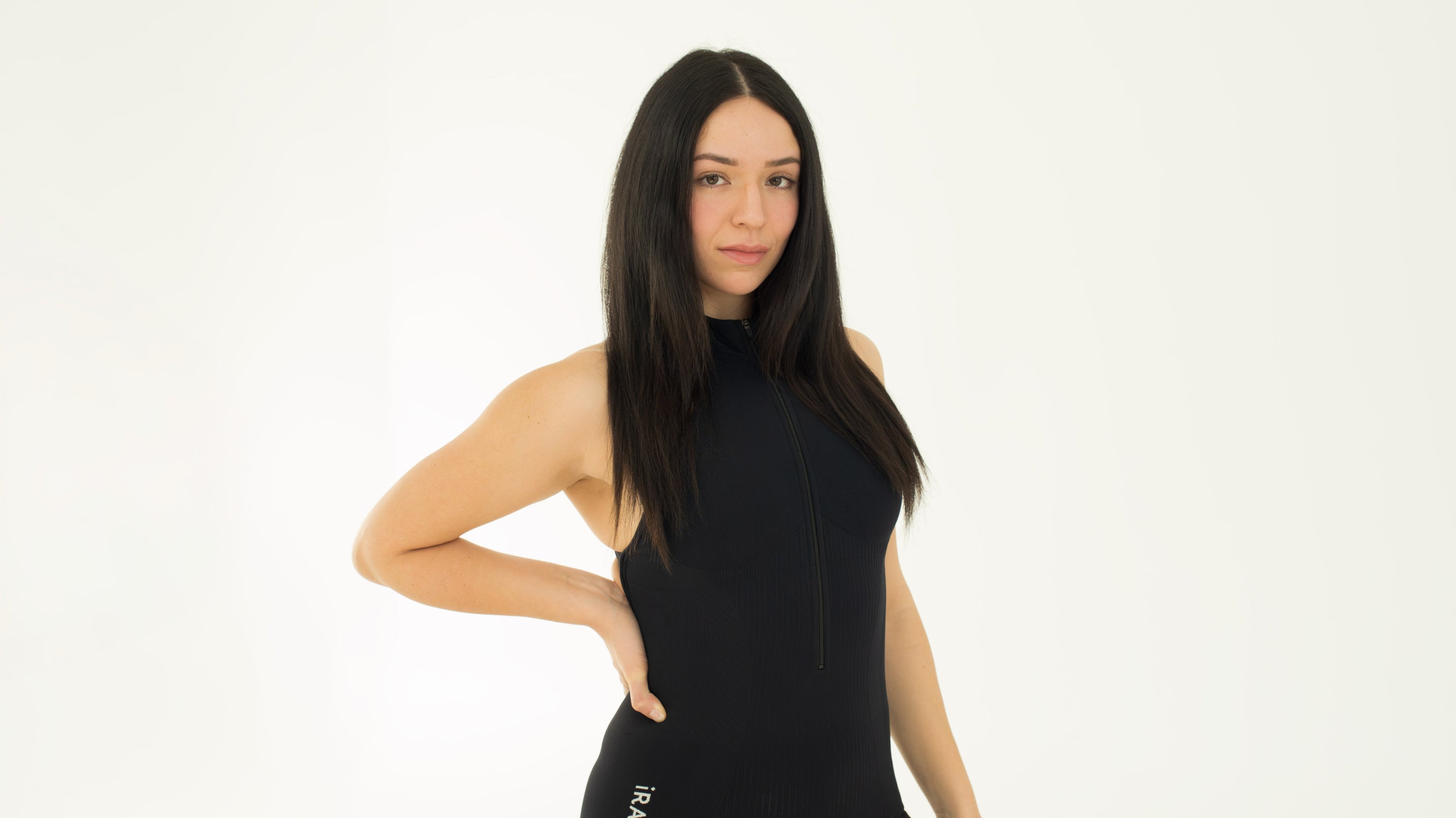 black seamless open back jumpsuit, full body studio pose