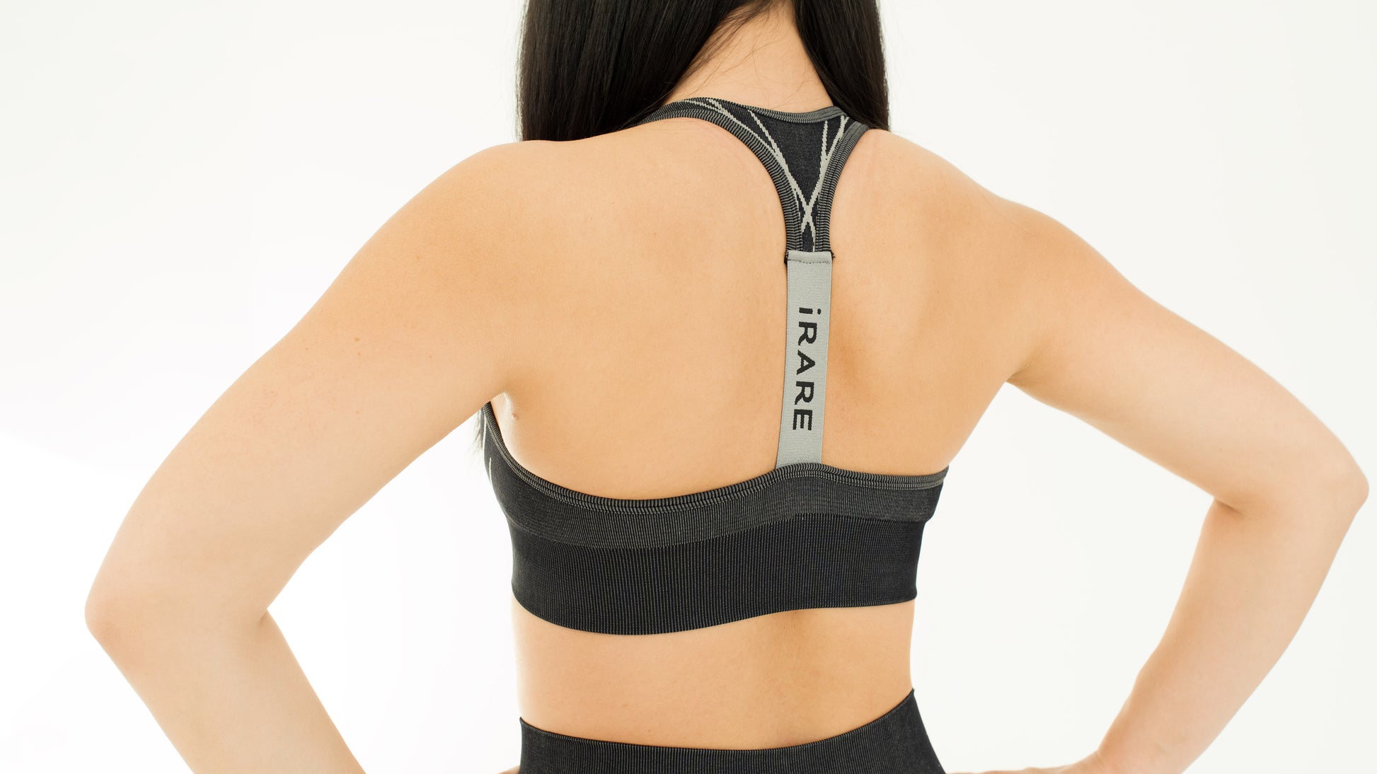 seamless sports bra in black, back view, studio