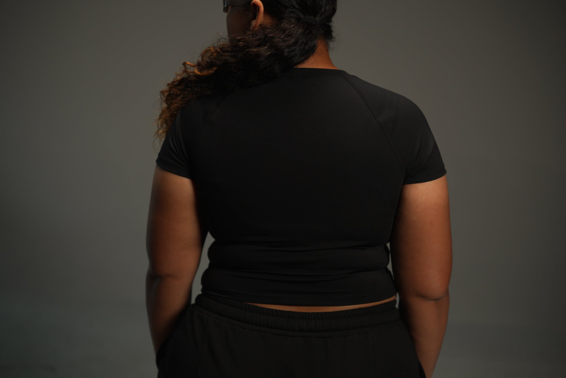 short-sleeve raglan top in black, back view close-up