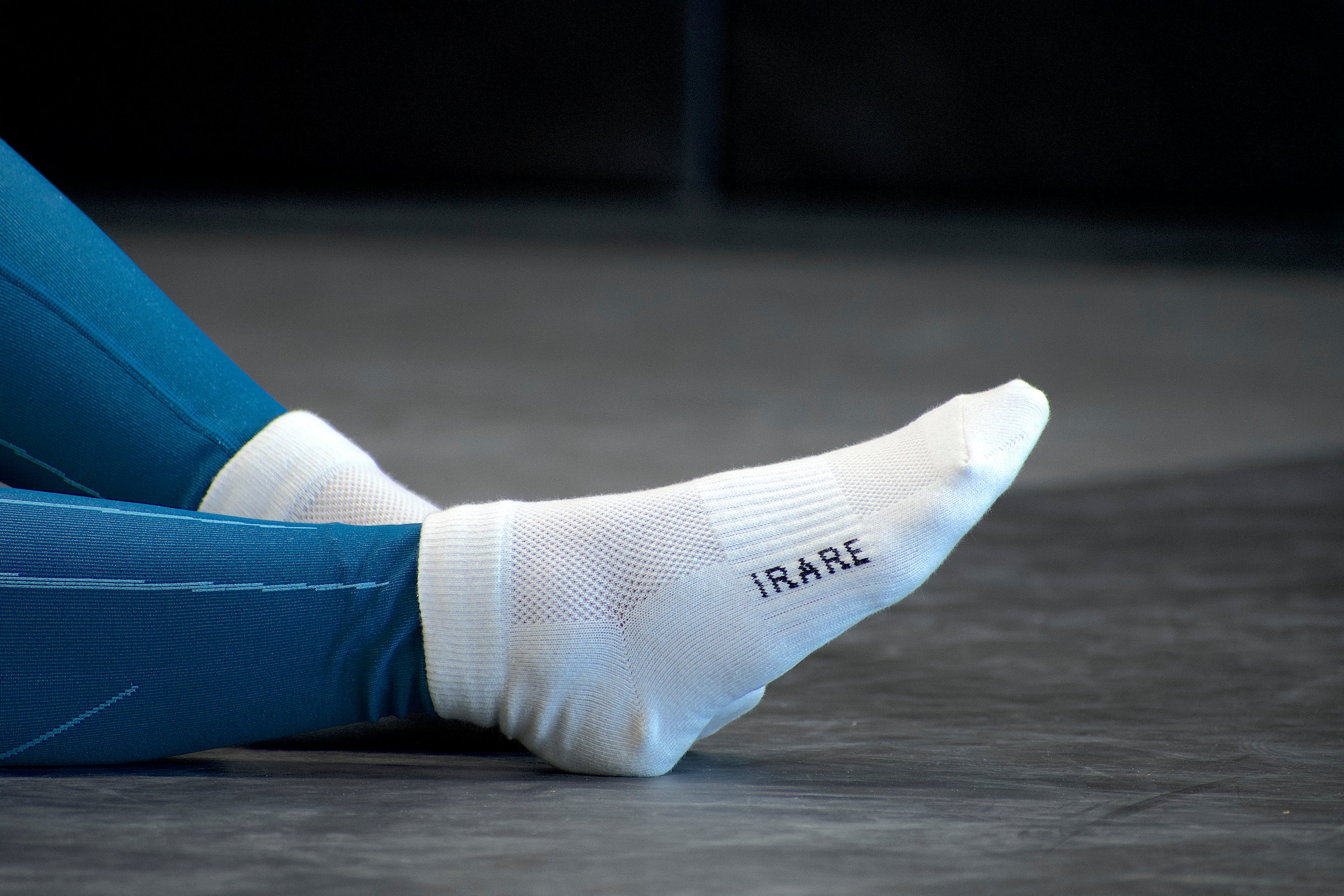 unisex ankle socks in white, gym floor, side view