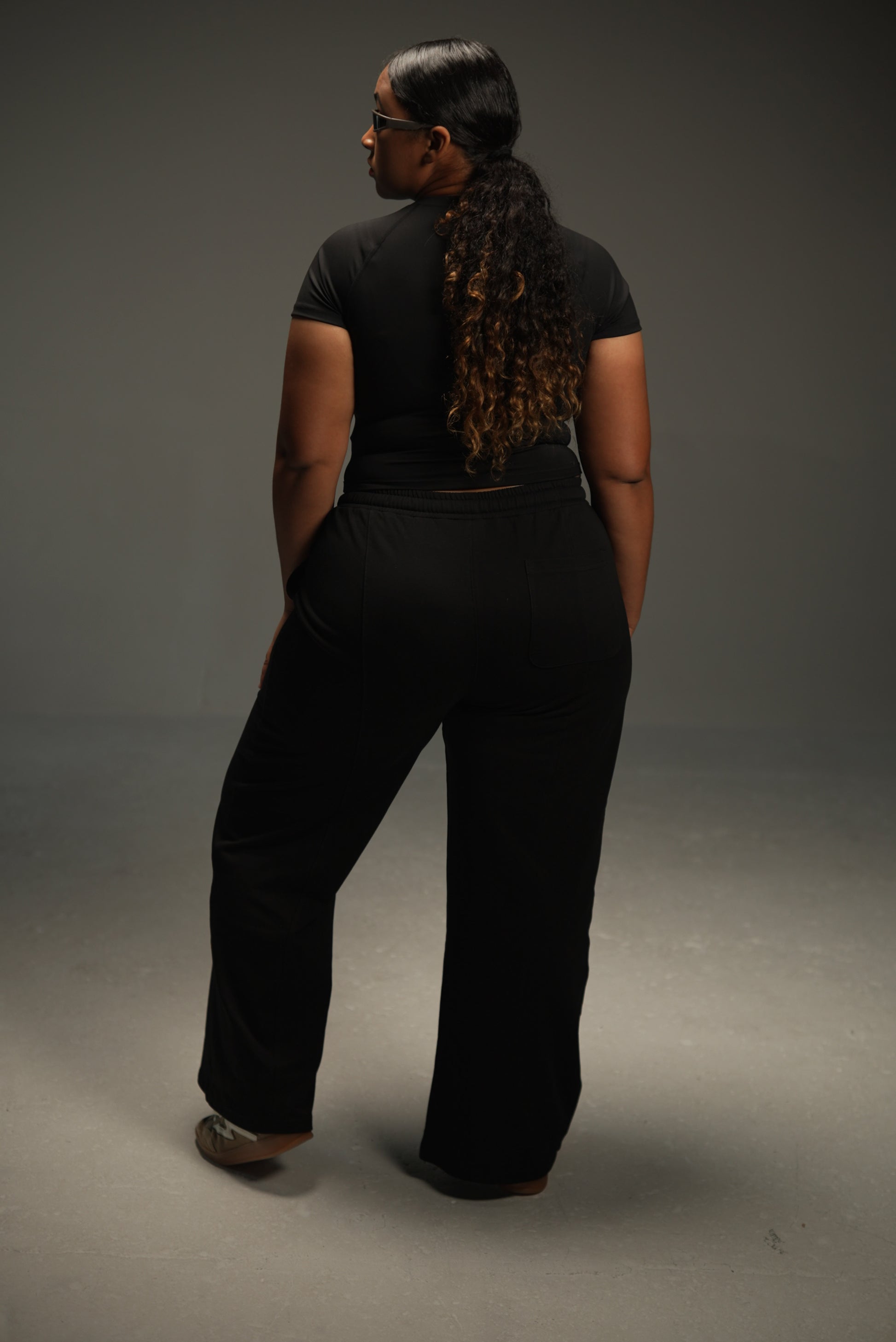 wide-leg sweatpants in black, on-model back, full length