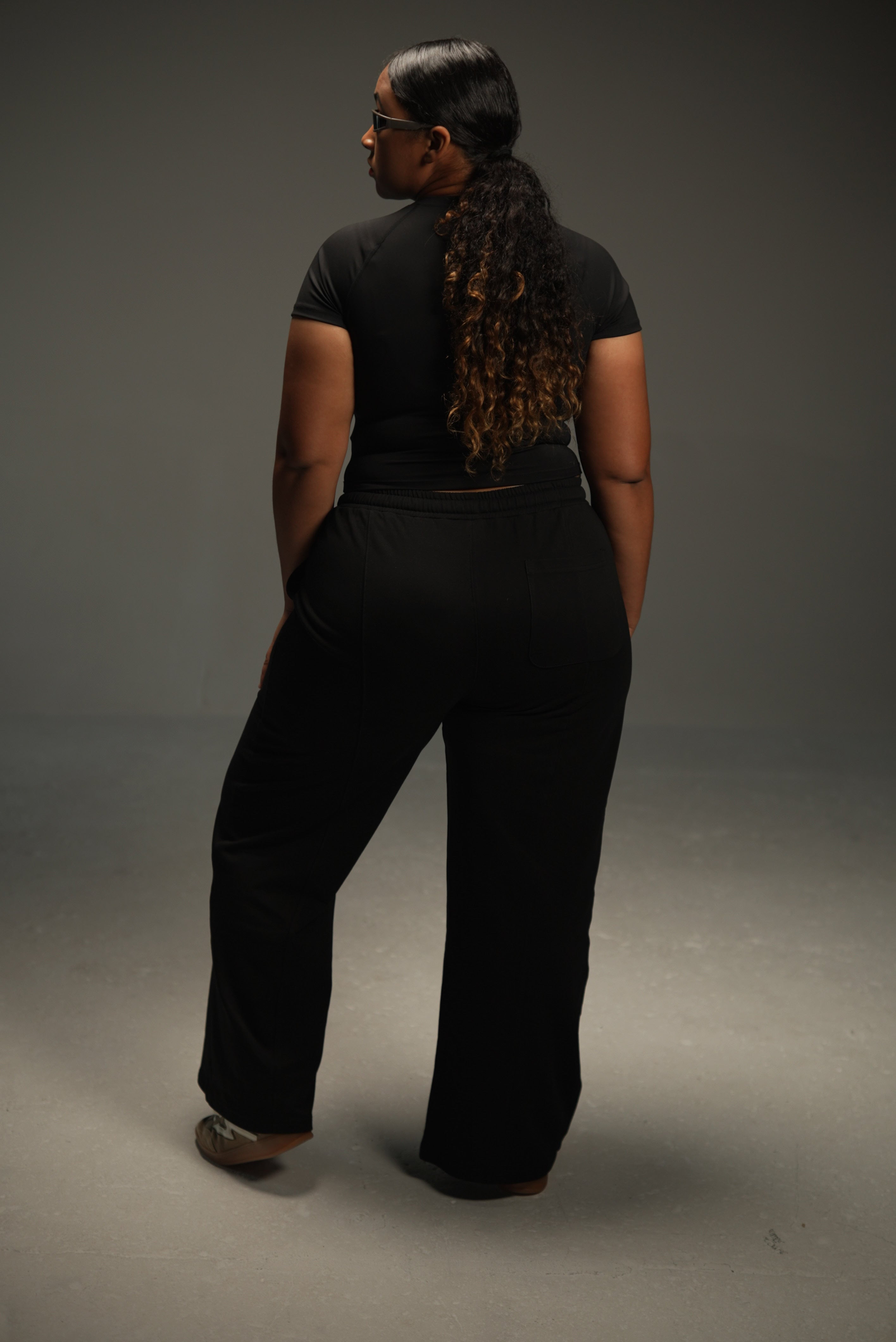 wide-leg sweatpants in black, on-model back, full length