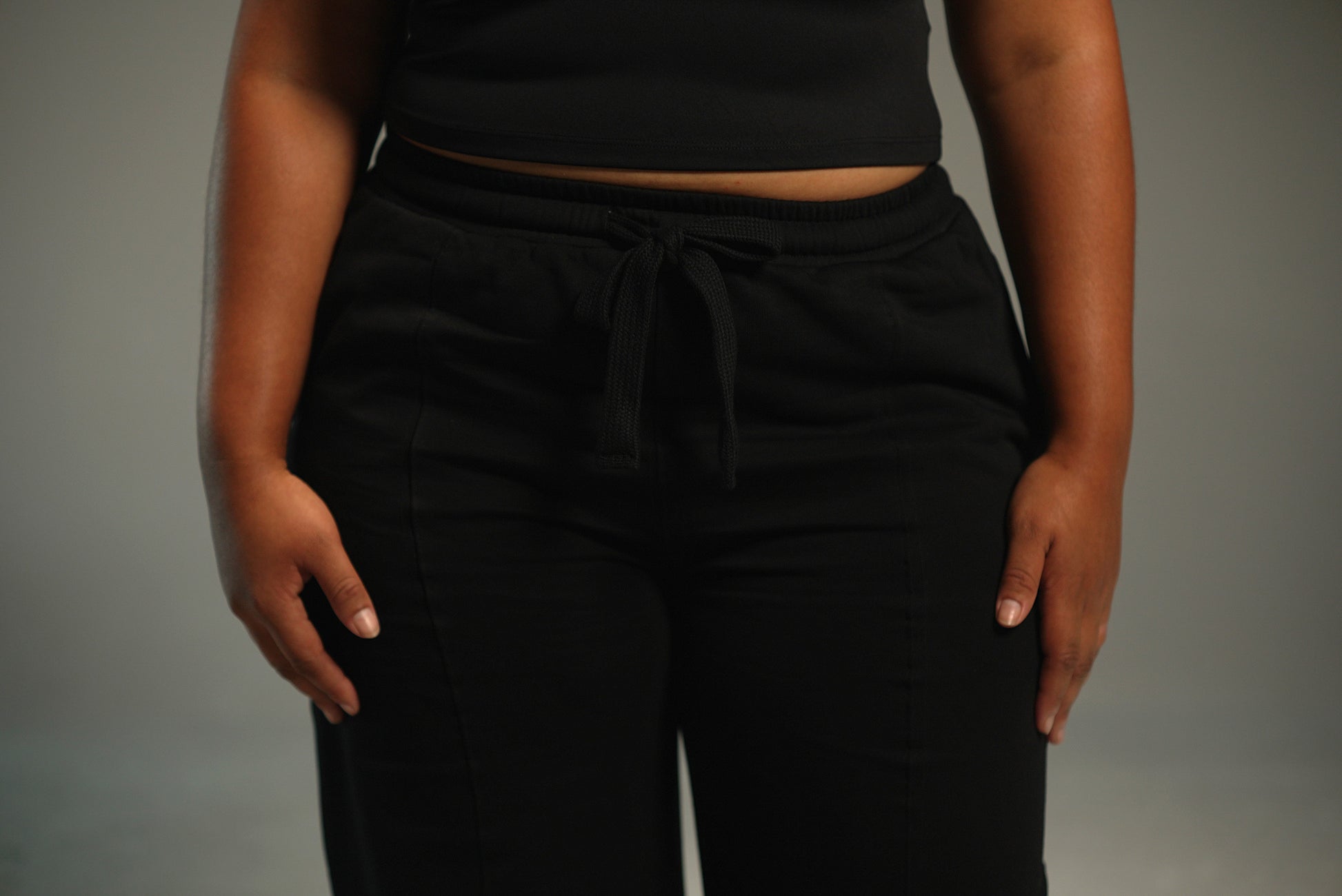 black wide-leg sweatpants, waistband drawstring detail