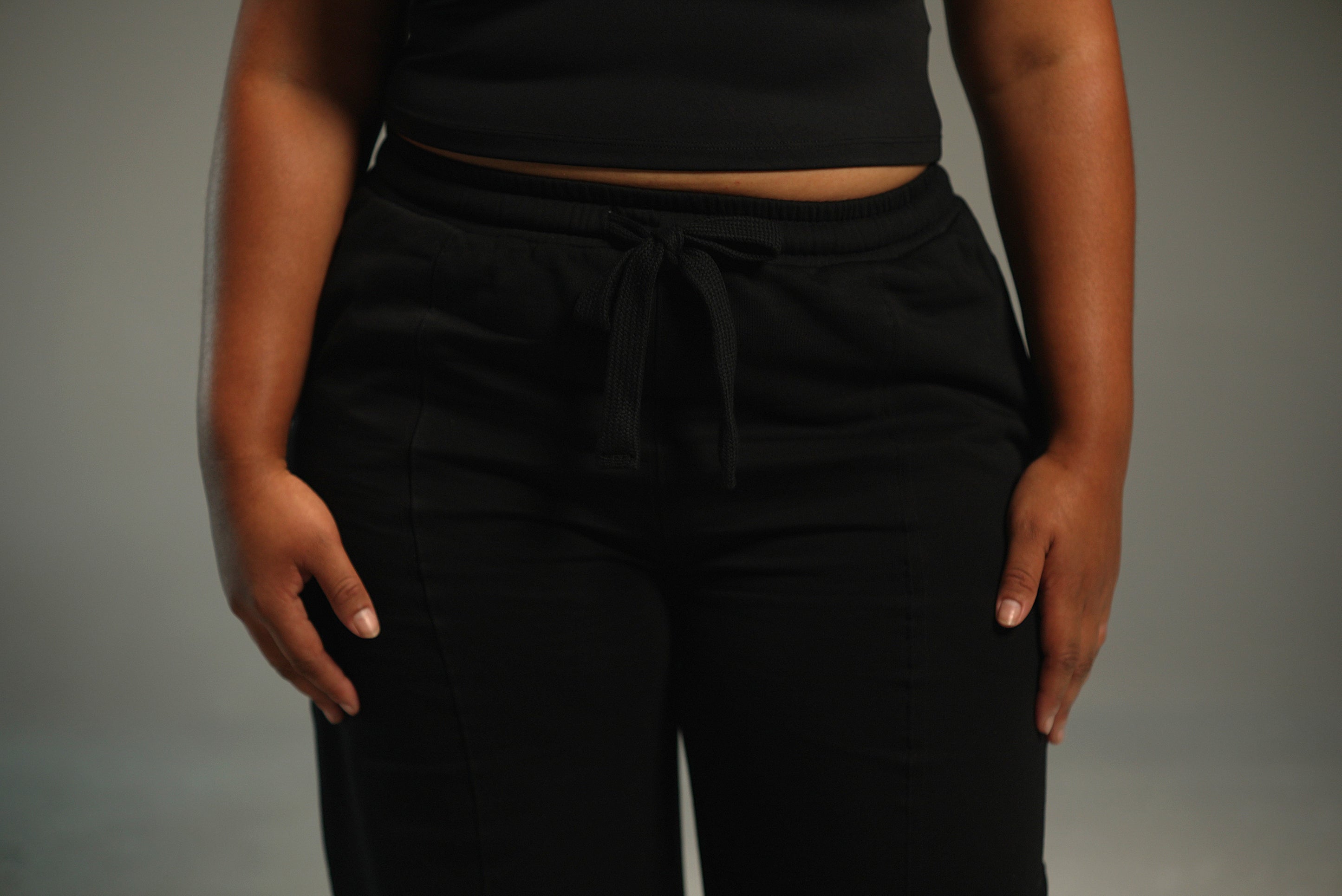 black wide-leg sweatpants, waistband drawstring detail