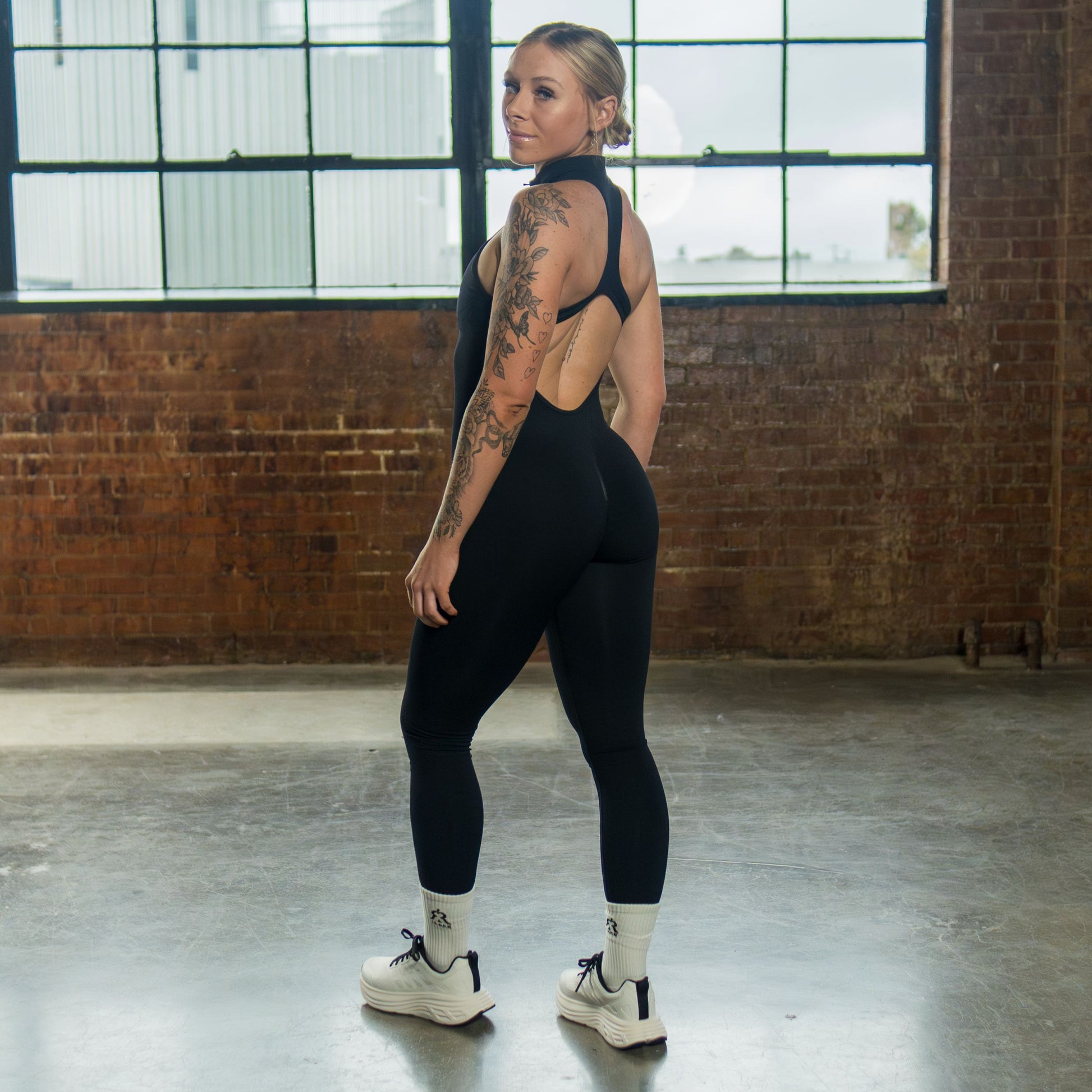 women’s seamless open-back jumpsuit black three-quarter back view
