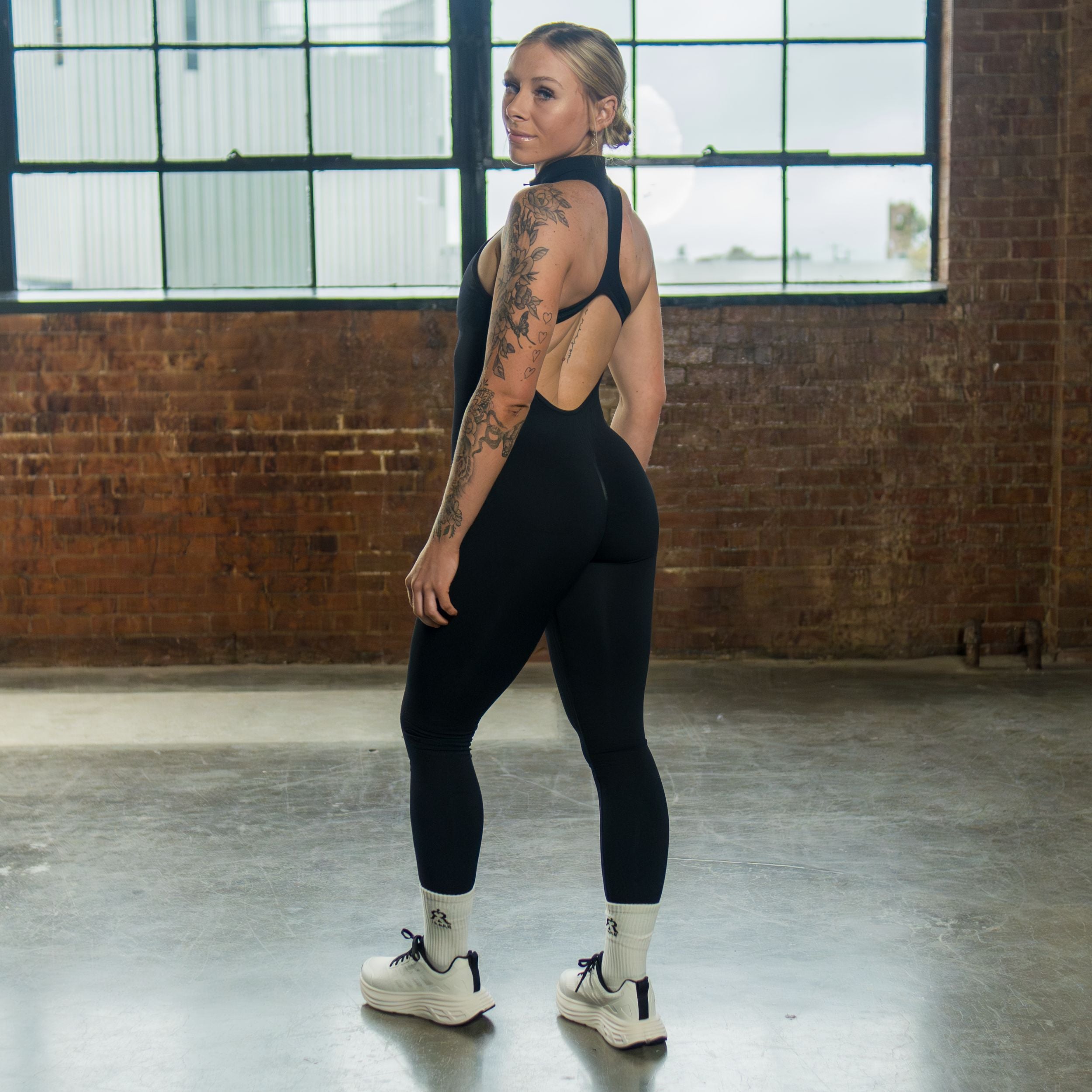 women’s seamless open-back jumpsuit black three-quarter back view
